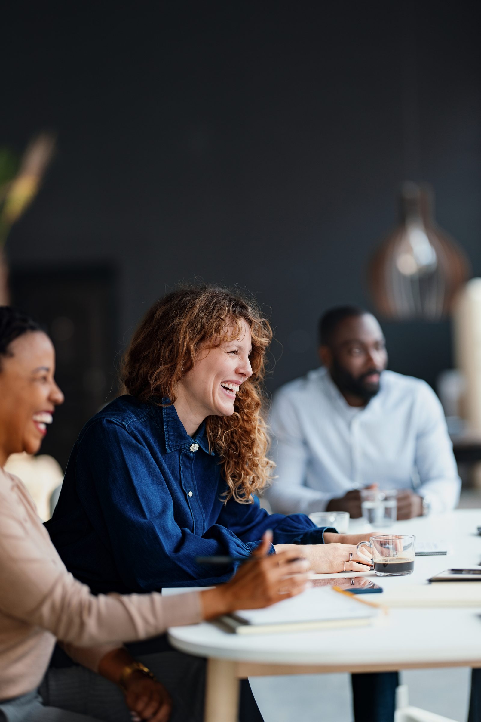 Colleagues around a table in a meeting room